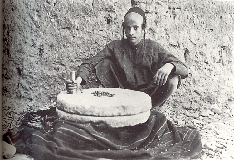 A young Jewish teenager grinds coffee beans in Sanaa, Yemen. (c) Carl Rathjens